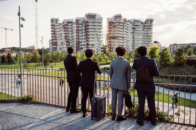 four-professionals-observing-the-cityscape-from-a-2024-07-05-00-47-53-utc.jpg